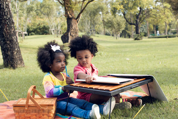 Little african boy and girl playing in backyard