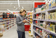 © lado2016 - Man shopping in supermarket, reading product information