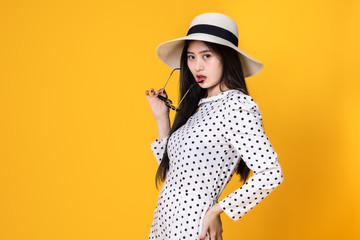 Asian woman in summer casual clothes.She smiling and  happy shopping. she  lovely attractive shine on  yellow background.Summer Surprise Sale  concept.