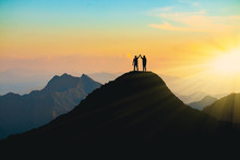 The Silhouette Of Lovers On The Top Of The Mountain During Sunset Time