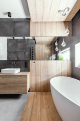 Wall Mural - Stylish bathroom with wooden and concrete walls and white bath