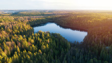 Aerial View Of Small Blue Lake In The Green Forest At Sunset In Finland, Nuuksio.