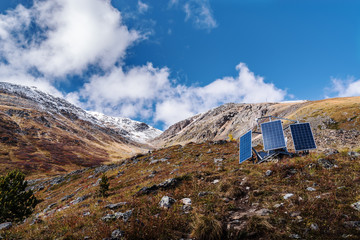 Wall Mural - Solar panels on the hillside. Aktru Valley, Severo-Chuysky ridge, Altai Republic, Russia