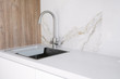 Kitchen sink and faucet on white kitchen