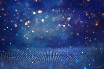 abstract glitter black, gold and blue lights background. de-focused