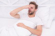 © be free - Snoring can increase risk headaches. Common symptom of sleep apnea. Causes of early morning headache. Migraine headaches. Sleep problems can lead to headaches in morning. Handsome man relaxing in bed