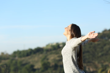 Wall Mural - Happy woman stretching arms breathing fresh air