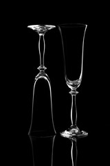 black and white image empty glass glasses on a black background with a reflection