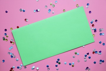 Valentine's day purple background with sparkles and green envelope. Copy space, celebration flat lay