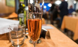 Fototapeta  - Glass of rose wine on the dining table in restaurant