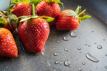 Wall Mural -  strawberry berries close up on a dark background