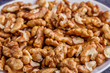 © mitsyko1971 - Walnuts shelled. Peeled Raw Walnuts. Fresh organic Nuts. Raw nuts. Many delicious Walnuts as a food background.