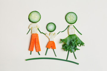 healthy family eating concept, cute man, woman and child made of fresh vegetables, top view, flat layout