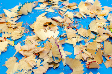 Wall Mural - on a blue background shavings from colored pencils