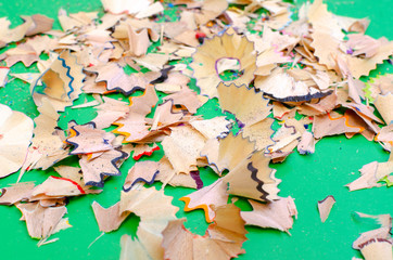 on a green background shavings from colored pencils