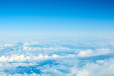 Fototapeta Niebo - View over the clouds. Blue sky and clouds.