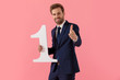 © Viorel Sima - Cheerful businessman holding a number one and pointing forward