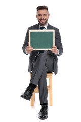 Canvas Print - happy young businessman holding green board