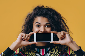 Pretty afro american woman isolated on yellow background.