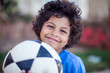 © Aleksej - Smiling kid boy holding ball outdoor. Children, sport and activity concept