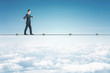 © Who is Danny - Businessman walking on rope on a blue sky background