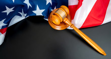 Pano Of Judge Gavel And Striking Block On Black Background And The American National Flag. Copy Space For Text. To Illustrate Crime Justice And Election In The Us.