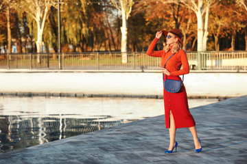 Wall Mural - Portrait of fashionable young woman near river