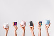 Female hands with credit cards, piggy banks and mobile phone on light background. Concept of online banking