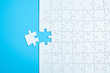 © Kenishirotie - Blue background made from white jigsaw puzzle pieces and place for your content