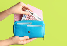 Female Hands With Wallet And Money On Color Background