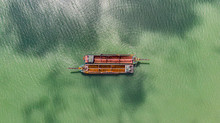 Old Fishing Boats On The Sea Off The Coast Of Malaysia From The Sky. Aerial View To Two Old Wooden Malaysian Fisher Boats On The Lebam River Near The City Of Singapore. Drone Capture At Johor Bahru
