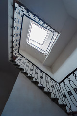 Poster - Square staircase, viewed from bottom. Building interior