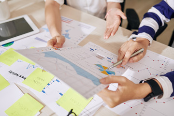 Wall Mural - Hands of female entrepreneurs analyzing financial report and planning company development