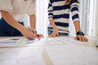 Cropped image of female entrepreneurs discussing charts with financial data, calculating expenses and planning work