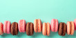 © fascinadora - Macarons banner with copy space. Colorful french macarons or macaroons on blue turquoise background. Top view or flat lay