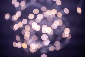 Wall Mural - The background is a golden bokeh of the glare of garland lights. Defocus