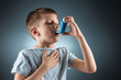 © Aliaksandr Marko - Portrait of a boy using an asthma inhaler to treat inflammatory diseases, shortness of breath. The concept of treatment for cough, allergies, respiratory tract disease.
