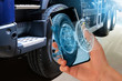 © scharfsinn86 - Serviceman repairing a truck using augmented reality application.