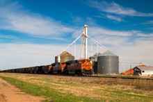 BNSF Railway, A Freight Train With An Orange Locomotive, Claude, Texas