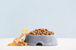 © Pixel-Shot - Bowl with dry pet food on table