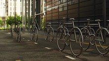 Cinematic Wide 4K Shot With Forward Motion Of Steel Bicycle Shaped Parking Solution In Evening Daylight With Traffic In Background, In Residential Part Of The Barcode Quarter Of Bjørvika, Oslo Norway.