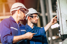 Industry Engineer Team Worker Teaching Help Friend Operate Control Heavy Machine In Factory