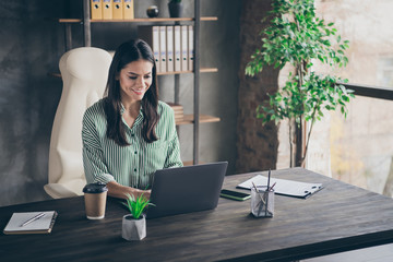 Portrait of her she nice-looking attractive cheerful focused content successful businesslady freelancer creating new design order client modern industrial brick loft interior style work place station