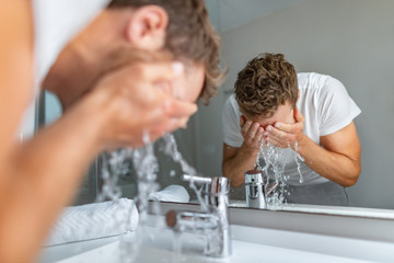 face wash man splashing water cleaning washing face with facial soap in bathroom sink. men taking ca