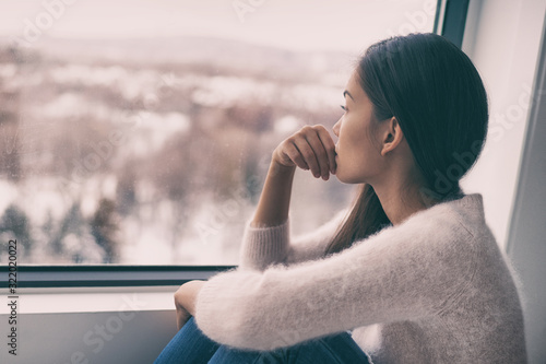 Fotomural Winter depression - seasonal affective disorder mental health woman sad comtemplative looking out the window alone