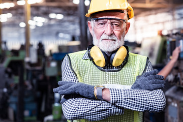 Industrial Engineers in Hard Hats.Work at the Heavy Industry Manufacturing Factory.industrial worker indoors in factory.aged man working in an industrial factory.