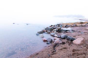 Sea view. foggy morning. stone coast