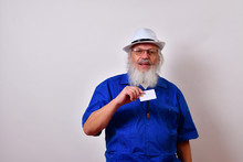 Mature Gentleman With A White Fedora Hat, Blue Guayabera Shirt And Bolo Tie. Showing His Credit Card He Uses For E-commerce.