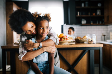 Wall Mural - mother and child having fun preparing healthy food in kitchen