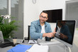 © W PRODUCTION - handsome young happy businessman casual wear at office business desk showing screen